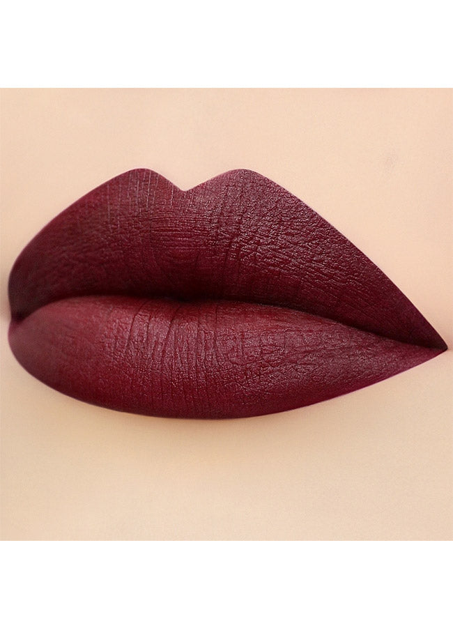 Burlesque (plum shade) lipstick swatch on paler skin