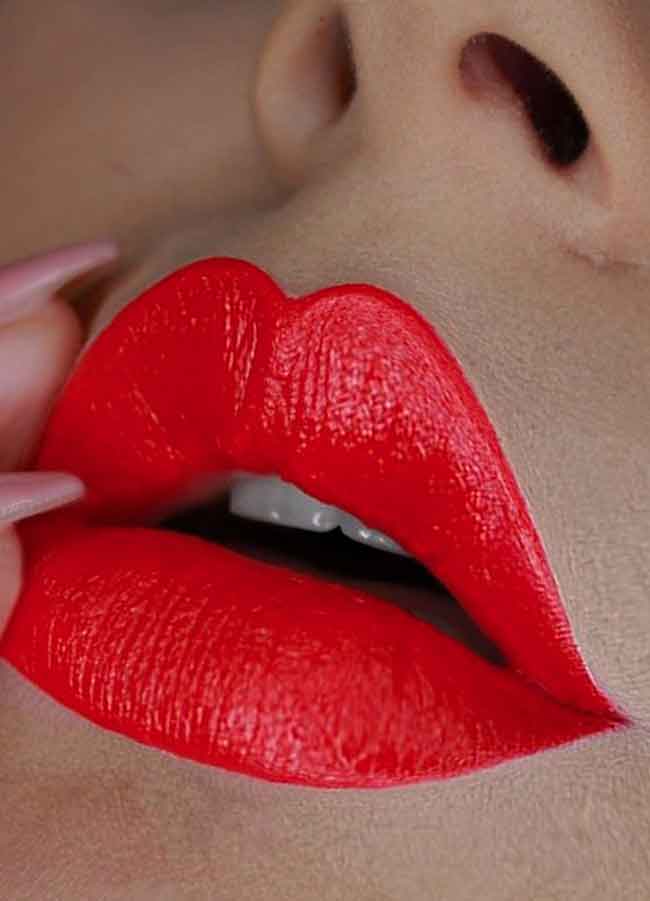 Socialite (bright coral red shade) lipstick swatch