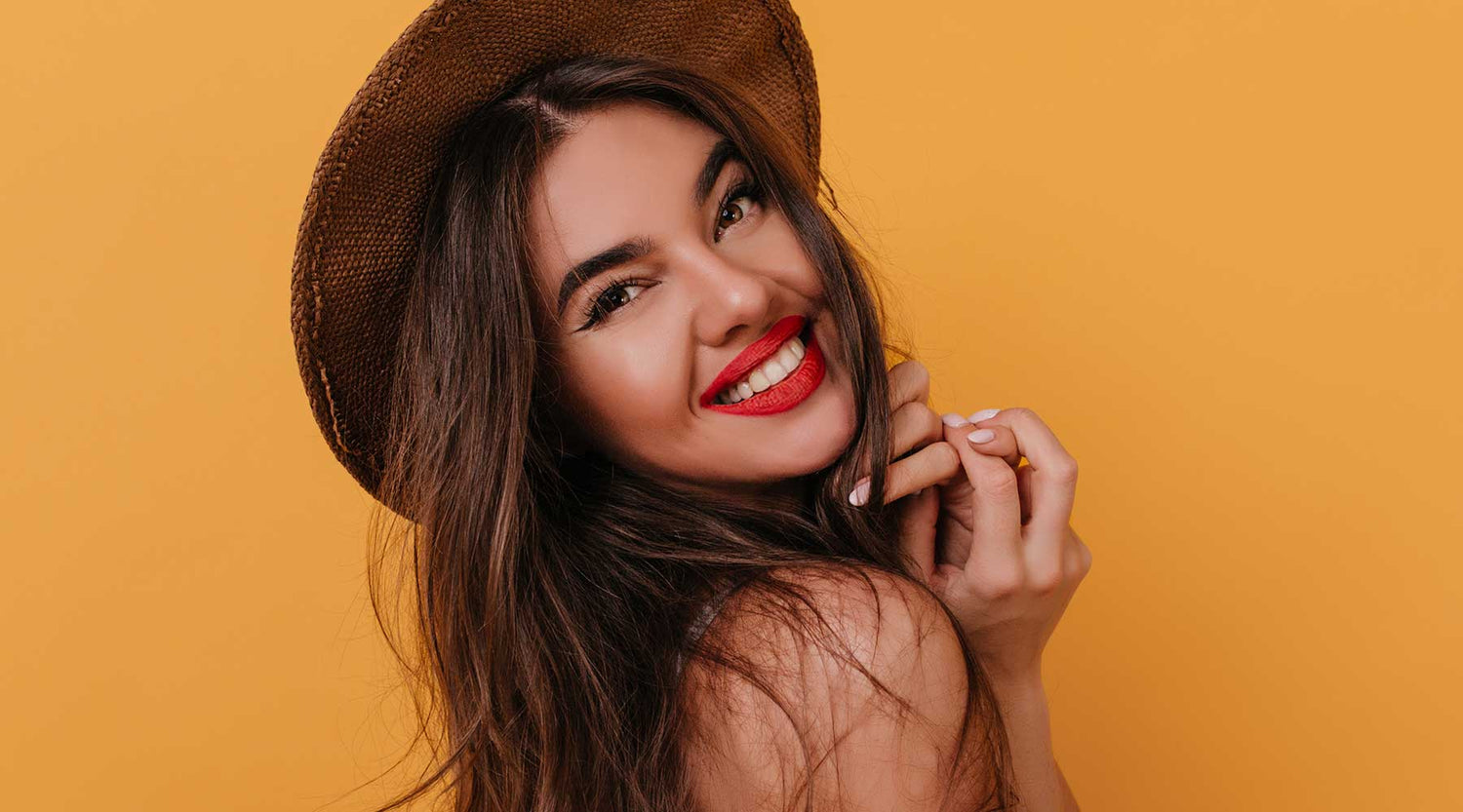 Beautiful model with bright red lips on a vibrant yellow background