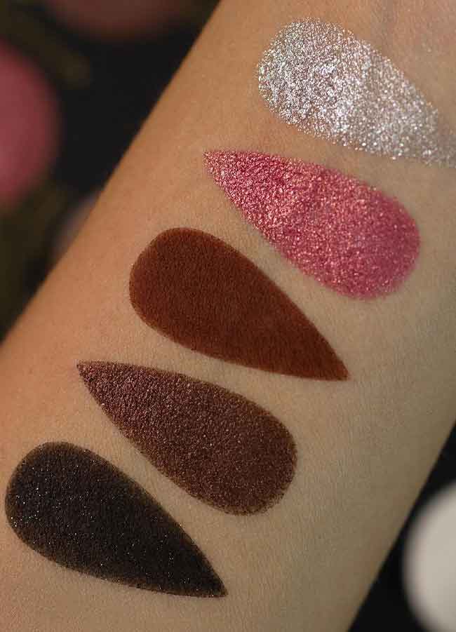 The Opera Eyeshadow Palette arm swatches showing silver, rose pink, dark brown, brown metallic and black shades.