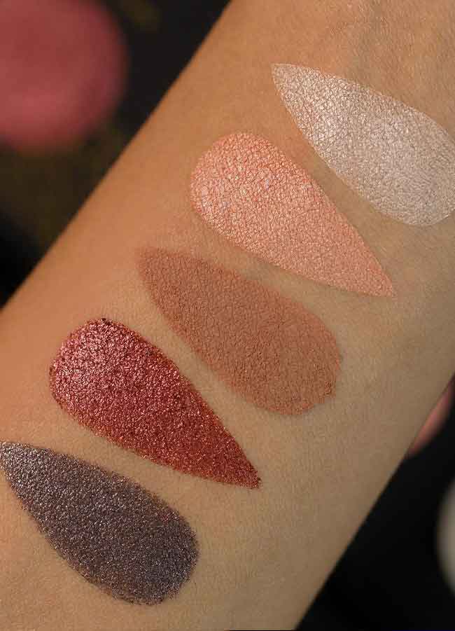 The Opera Eyeshadow Palette arm swatches showing white, baby pink, sand, rose pink metallic and silver metallic shades.