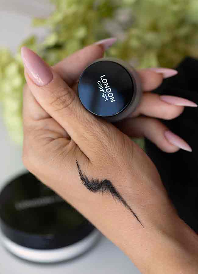 Gel Eyeliner pot closed with swatch on hand